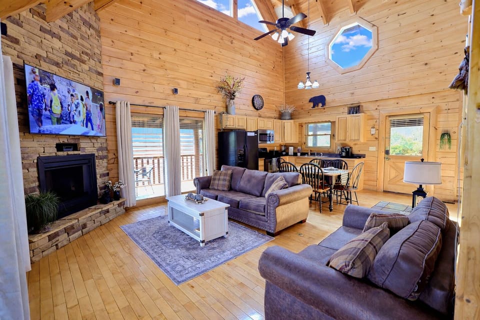 High ceilings, warm fireplace, and a comfy leather couch—perfect for family nights of movies and memories.