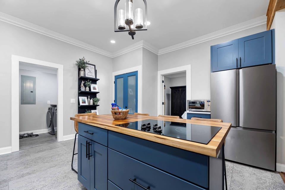 Electric cooktop in the butcher block island. 