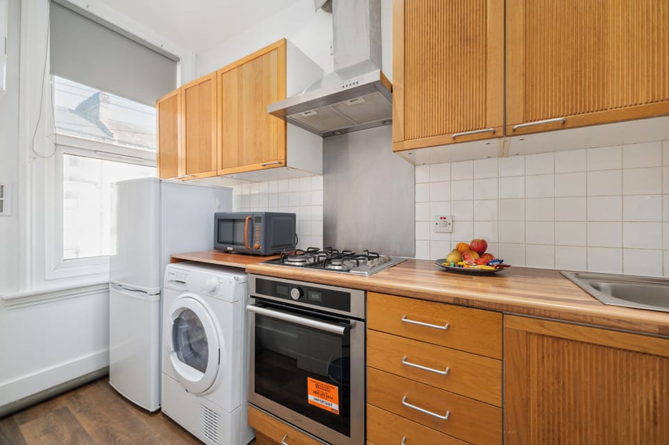 Modern kitchen with coffee maker, washer, and dryer included