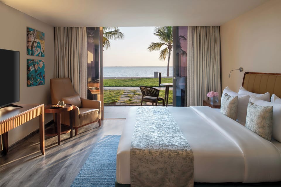 Deluxe Room, Patio, Sea View | In-room safe, desk, laptop workspace, blackout drapes