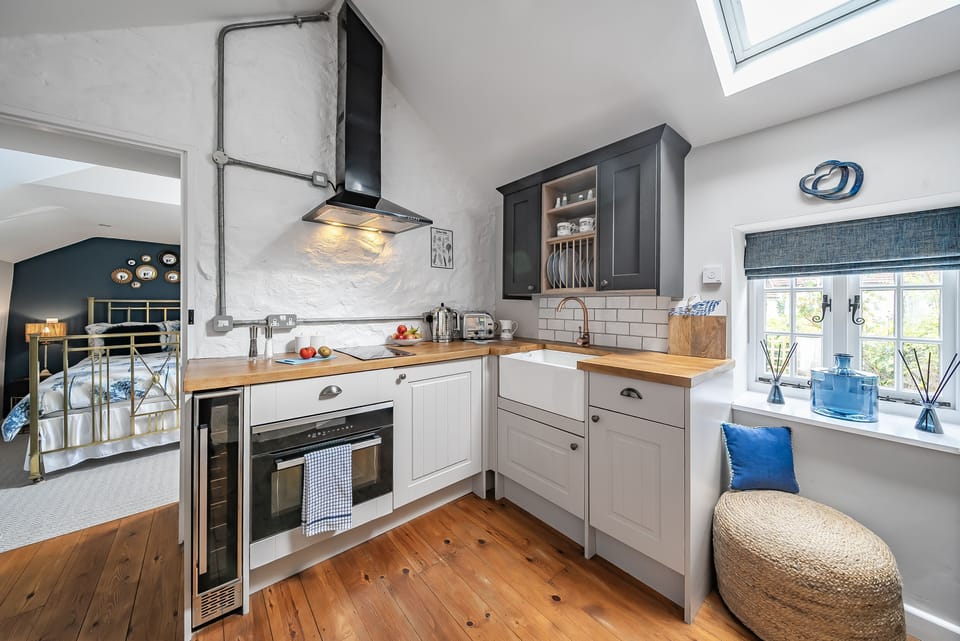 The Old Stables, Charmouth: The kitchen with oven and hob is ideal for preparing tasty treats