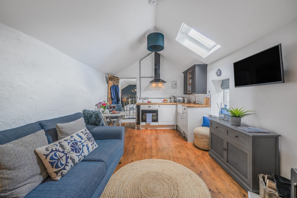 The Old Stables, Charmouth: The open-plan sitting area with kitchen is perfect for a couple's break