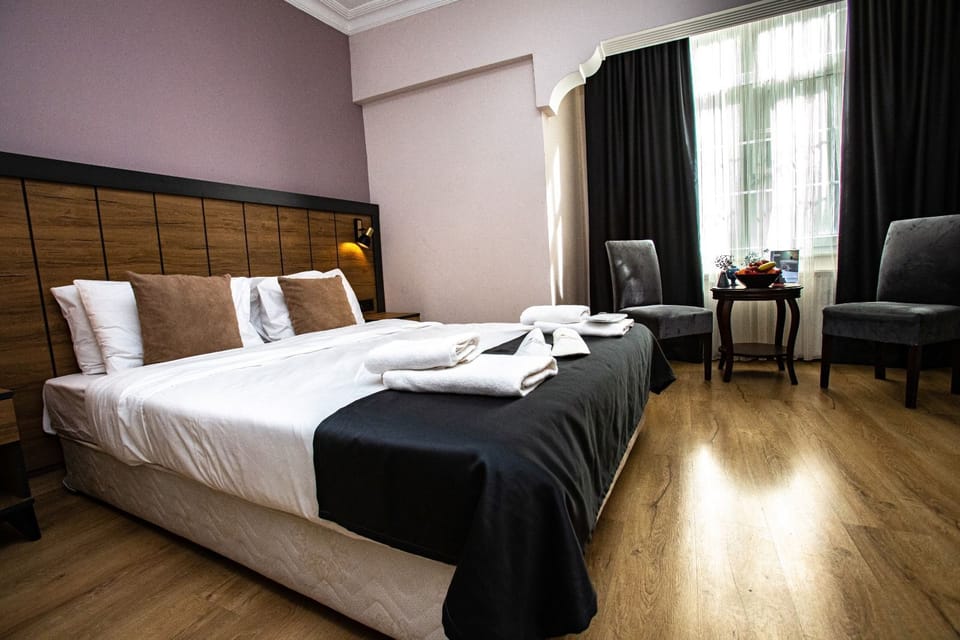 Standard Triple Room | In-room safe, desk, laptop workspace, blackout drapes