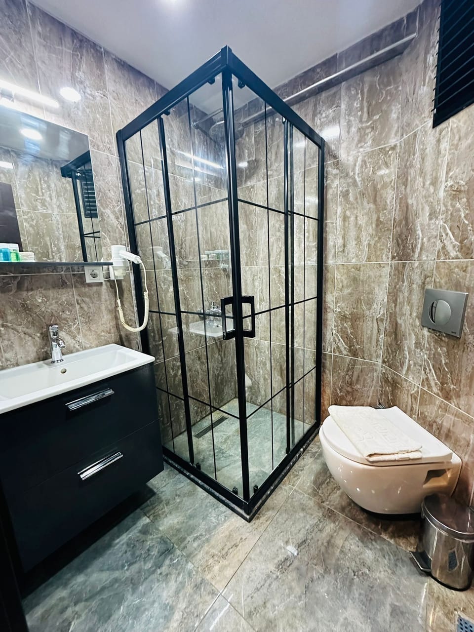 Shower, hair dryer, slippers, towels