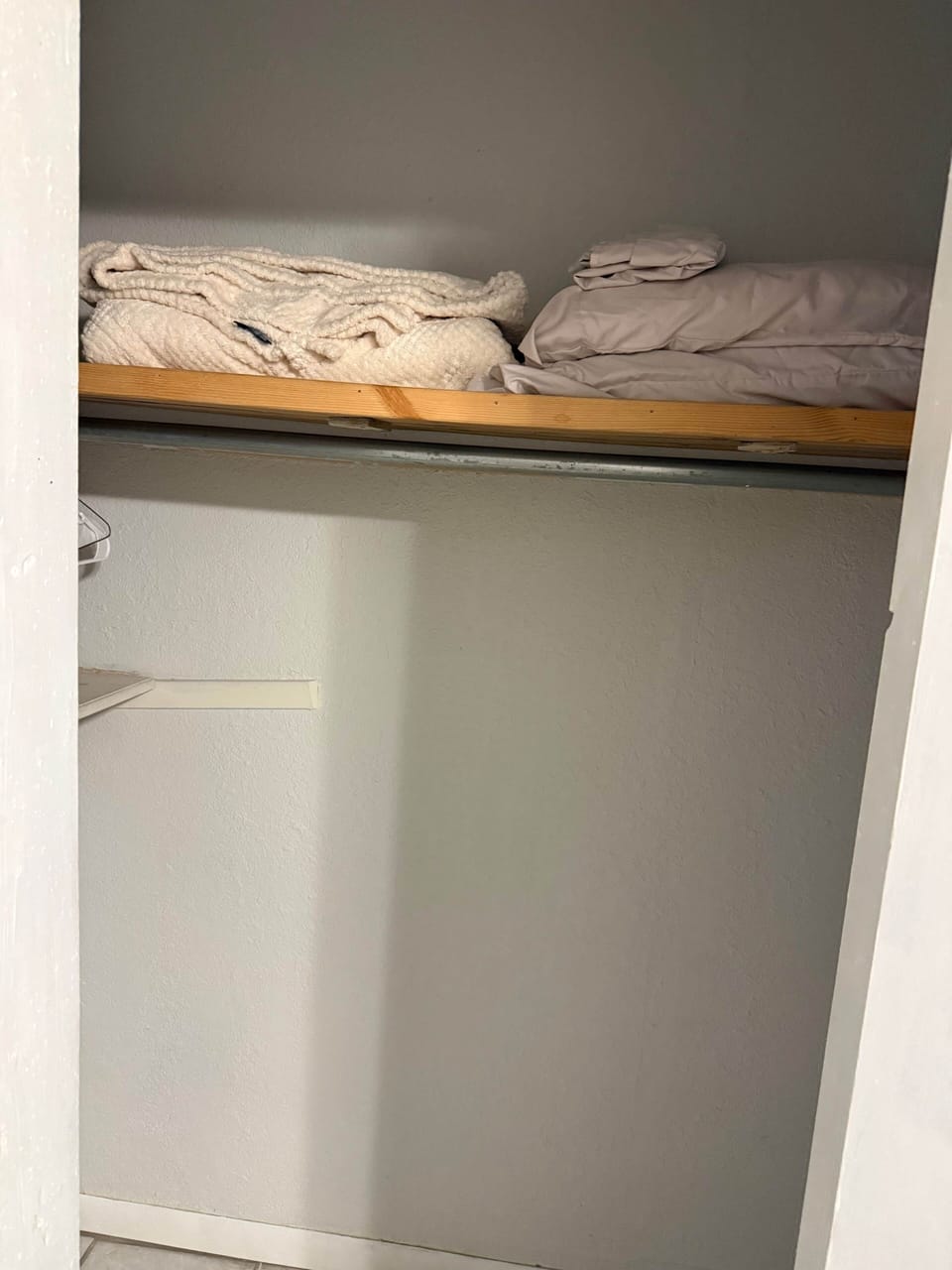 Extra pillows and blanket in closet. 