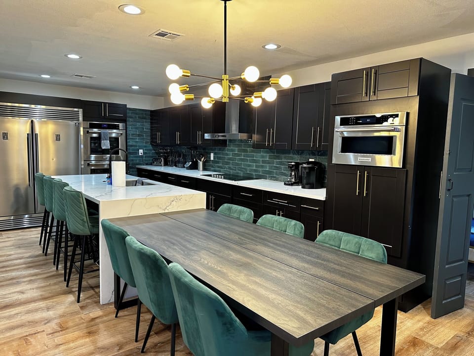 New kitchen with double oven, built in microwave and electric stovetop 