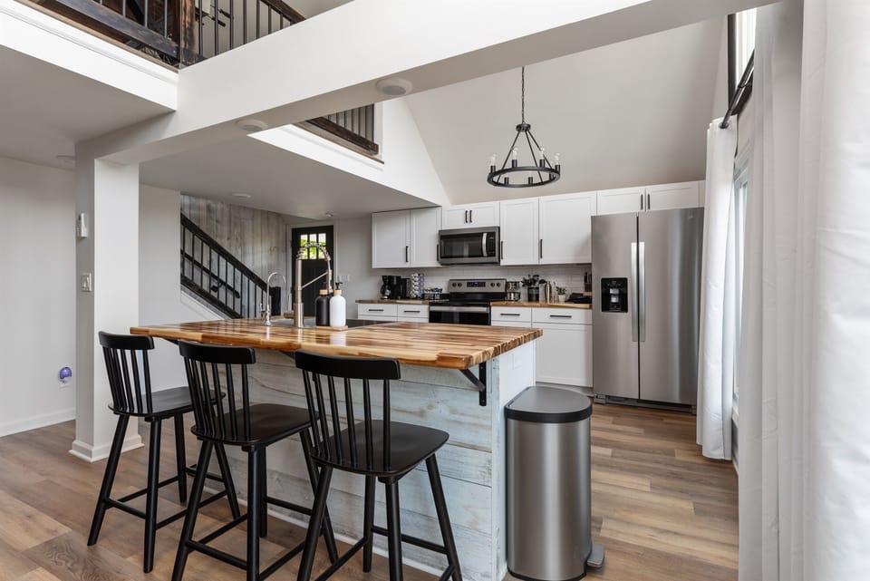 Enter the house with an open concept kitchen w/island next to the dining area