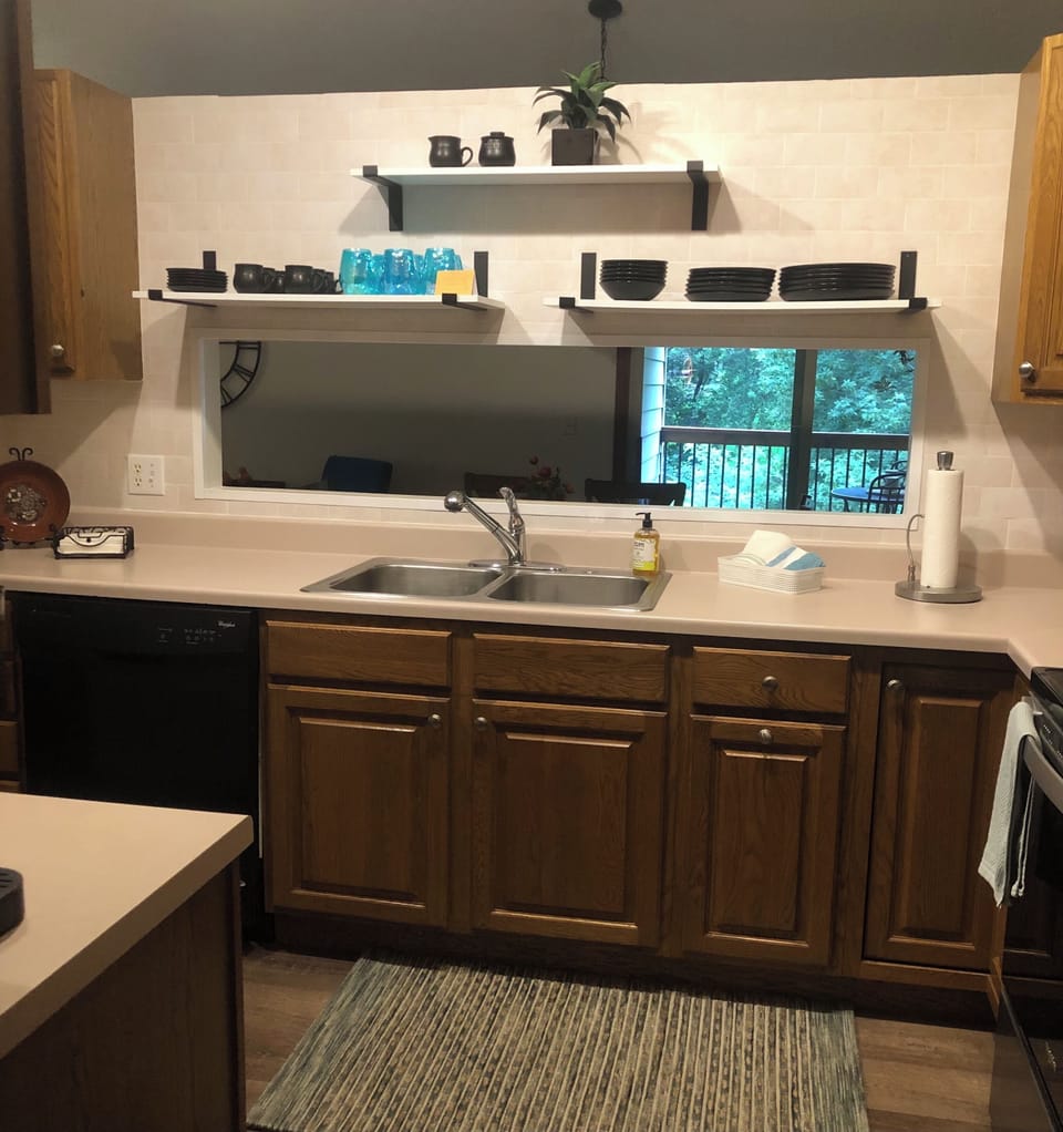 Kitchen open to dining and back yard view