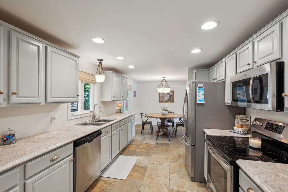 Modern fully-stocked kitchen equipped with stainless steel appliances perfect for cooking and socializing.