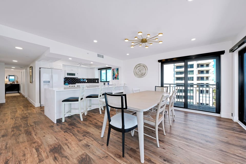 The dining area accommodates 10 with seating at the dining table and kitchen counter