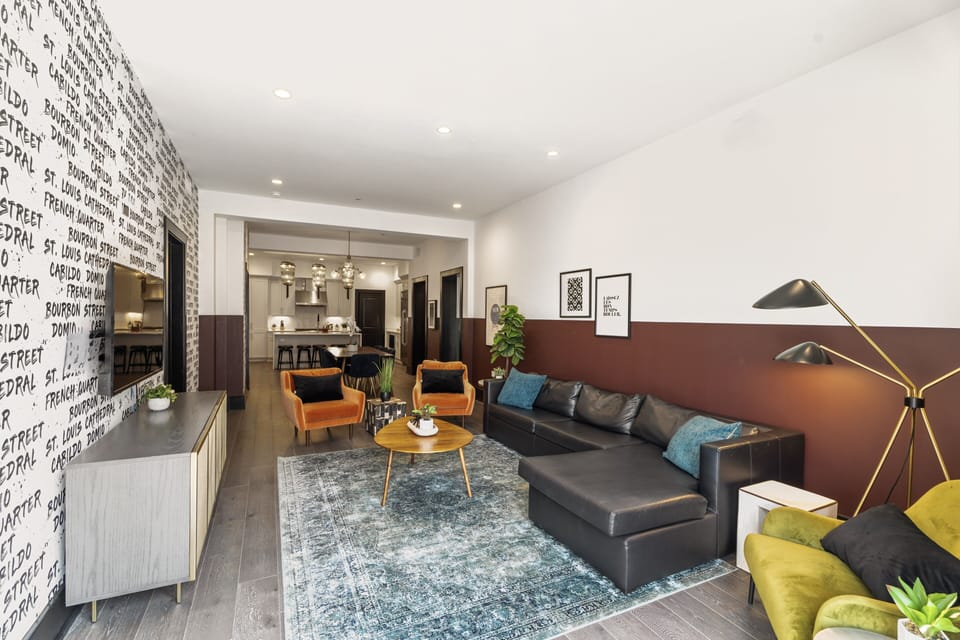 Relax in the living area with a smart TV, stylish seating, and a sleeper sofa for extra guests. Perfect for families or group stays in New Orleans, this inviting space is ideal for movie nights or recharging after a day in the city.