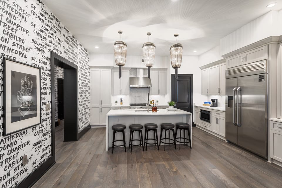 Cook or snack in style with a full kitchen featuring GE stainless appliances, cookware, and an island with bar seating. Ideal for short or extended stays, our kitchens make group travel in New Orleans easy and comfortable.