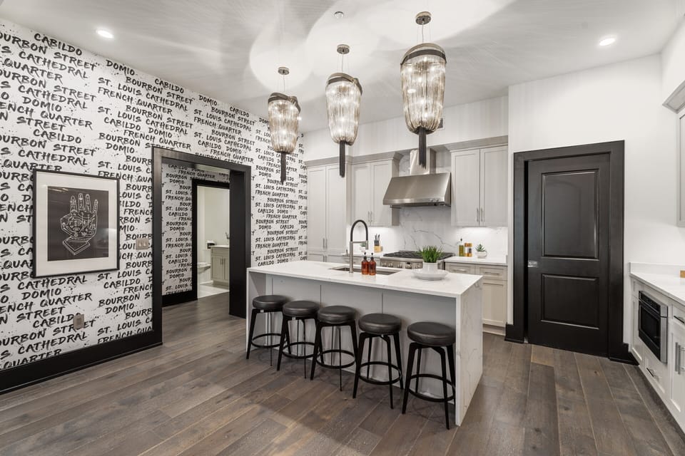 Cook or snack in style with a full kitchen featuring GE stainless appliances, cookware, and an island with bar seating. Ideal for short or extended stays, our kitchens make group travel in New Orleans easy and comfortable.