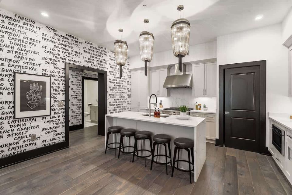 Cook or snack in style with a full kitchen featuring GE stainless appliances, cookware, and an island with bar seating. Ideal for short or extended stays, our kitchens make group travel in New Orleans easy and comfortable.