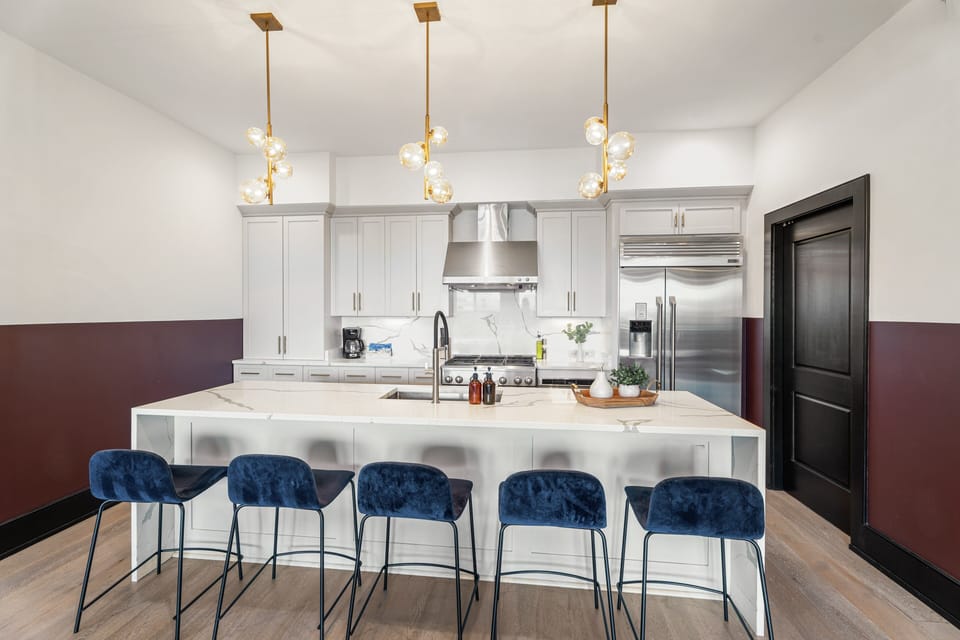 Cook or snack in style with a full kitchen featuring GE stainless appliances, cookware, and an island with bar seating. Ideal for short or extended stays, our kitchens make group travel in New Orleans easy and comfortable.
