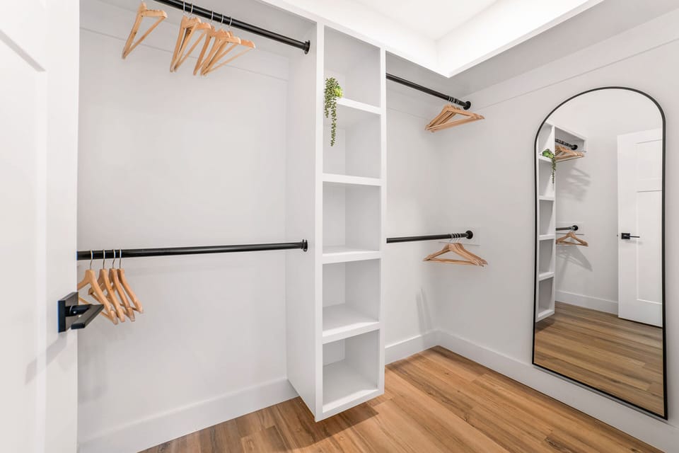 Spacious walk-in closet with sleek shelves & mirror - unpack in style!