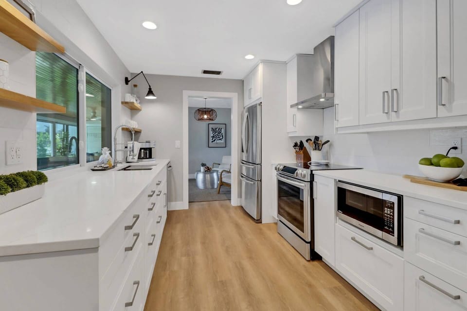 The beautifully updated kitchen is well equipped with upgraded appliances including oven, dishwasher, refrigerator/freezer and microwave.