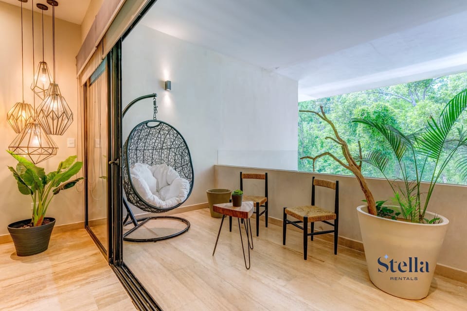 Your balcony spot: chill with jungle views and a cool swing.