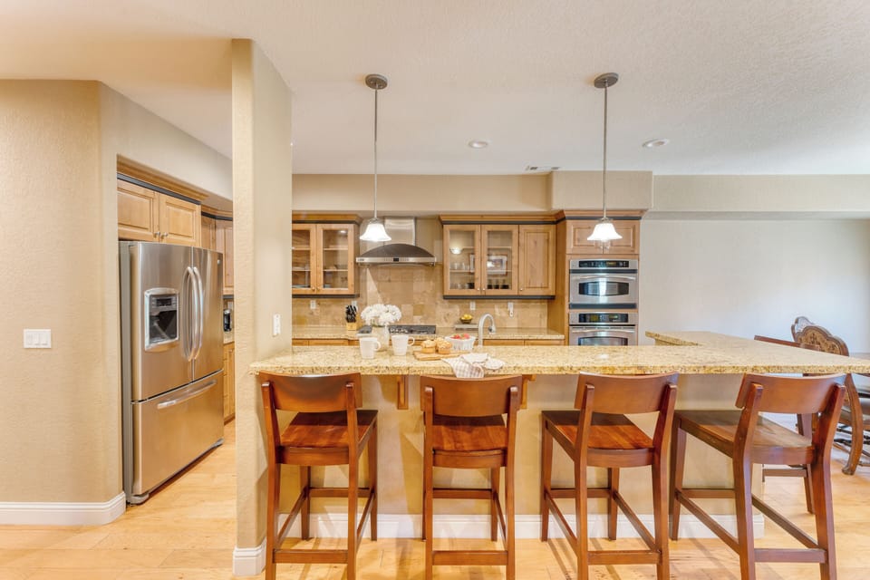 Kitchen is fully equipped and features stainless steel appliances.