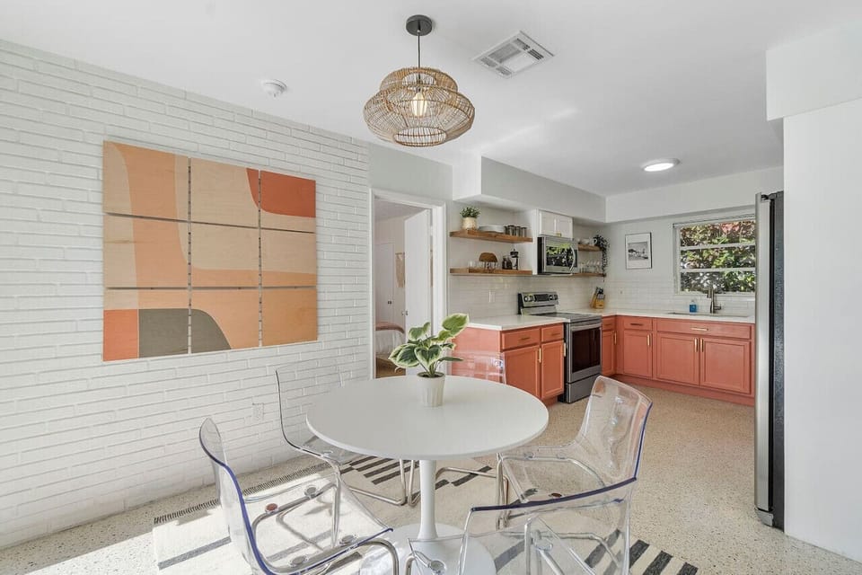 A functional kitchen area paired with a comfortable dining setup, creating a seamless and stylish space for cooking and dining.