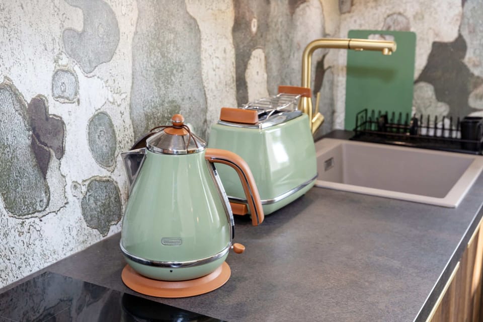 Modern kitchen amenities including a retro-style kettle and toaster, perfect for morning coffee or light snacks.
