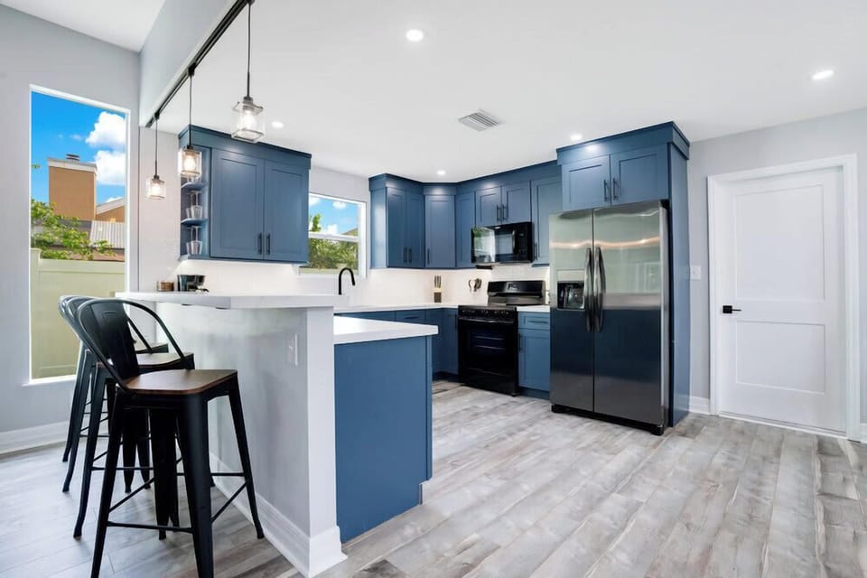 Modern kitchen with blue cabinetry and stainless steel appliances
