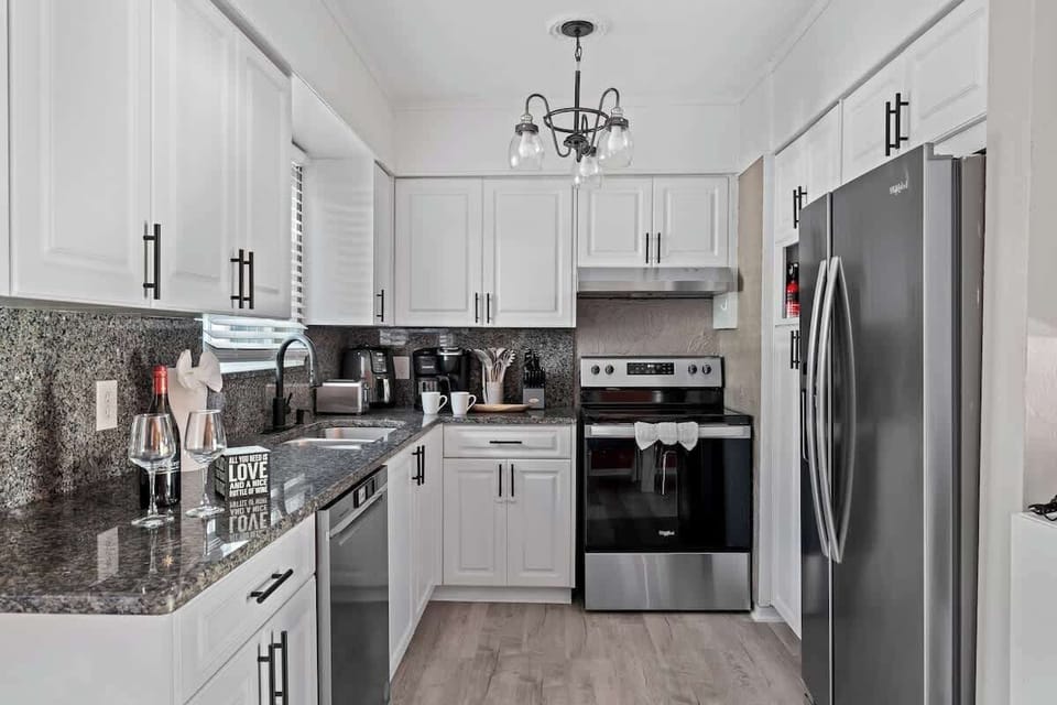 Full view of the kitchen featuring beautiful white cabinets and sleek stainless steel appliances, perfect for all your culinary needs.