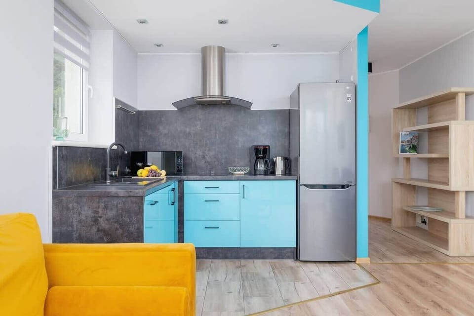 This stylish kitchen is laid out in an L-shape, combining turquoise and neutral tones, ideal for cooking and entertaining.