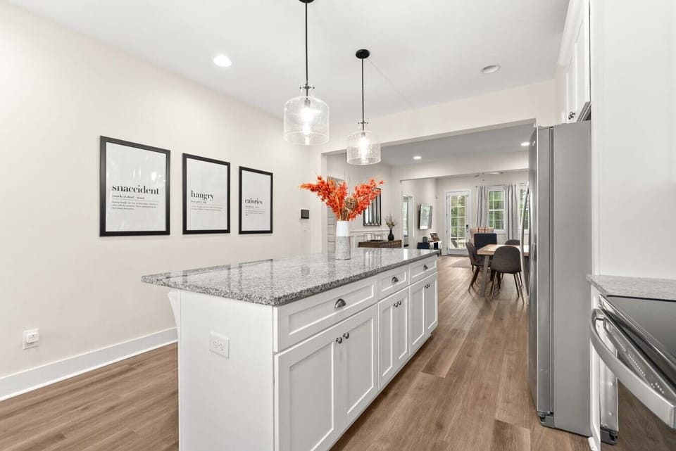 Gather around the oversized island—perfect for morning coffee, meals, and game-day conversations.