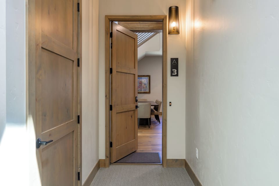 - Find your way through cozy carpeted hallways with soft lighting and rustic wood finishes - Modern wall sconce warmly welcomes you as you approach the spacious dining room