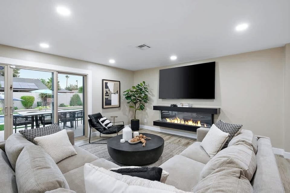 Relax in the spacious living room with cozy seating and a decorative fireplace.
