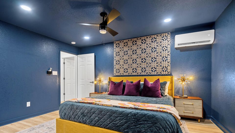 This king suite combines bold colors, cozy textures, and modern touches to create a relaxing retreat at the end of the day.