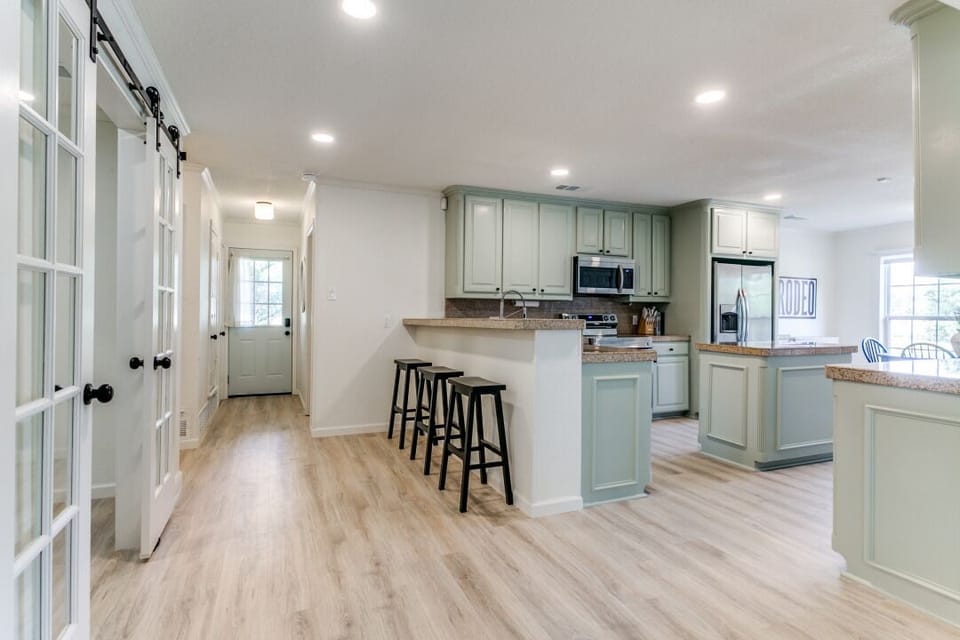 Cozy kitchen, with bar stool seating, equipped with all the necessities. 