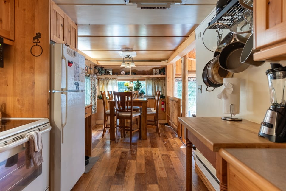 Well-equipped kitchen with essentials and a cozy dining area.