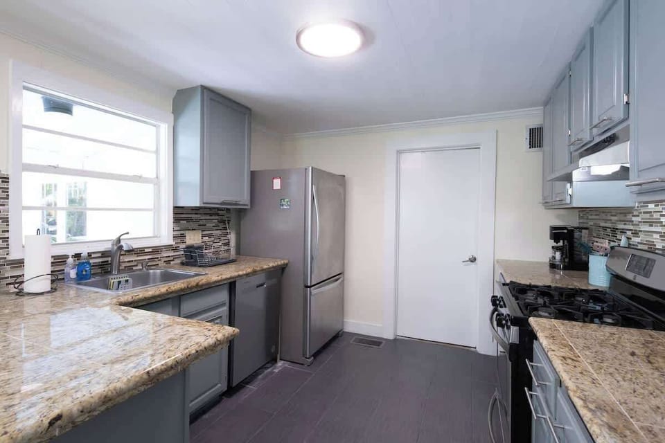 Fully Stocked Kitchen. Stainless steel fridge with ice. Gas stove. Dishwasher. Microwave (not shown in photo). Dinnerware for 16 - plates, bowls, and silverware. Mugs, glasses, plastic cups. Fire Extinguisher and first aid kit underneath sink. 