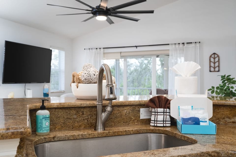 Open concept kitchen, living room, dining area. Light and bright.