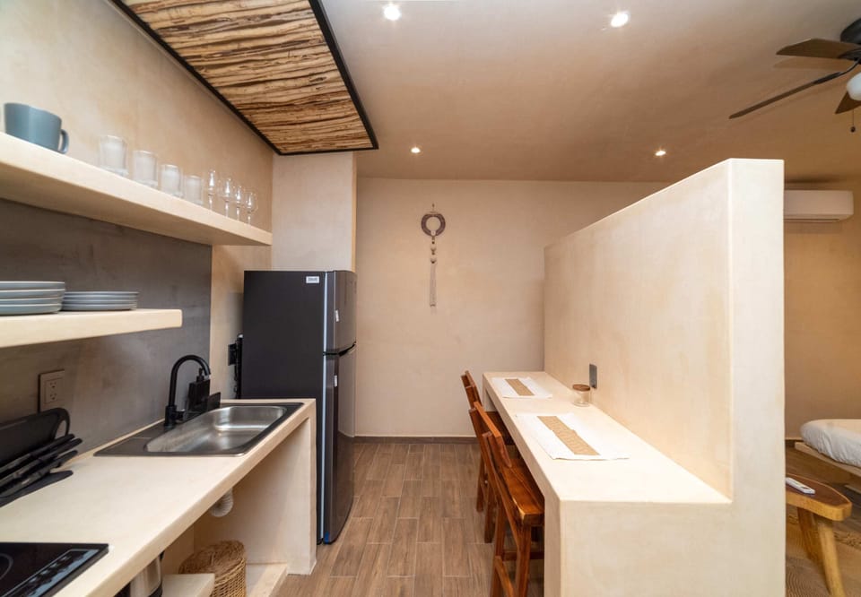 a bedroom with bed and TV in Tulum apartment rentals