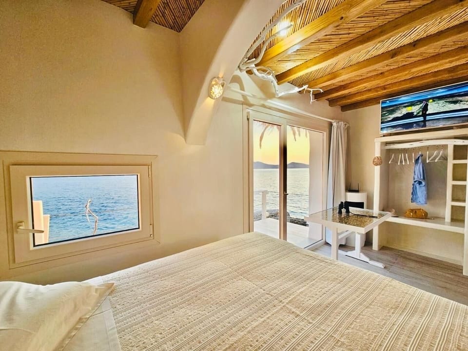 Milos island amazing view by your bed on the ochen water .