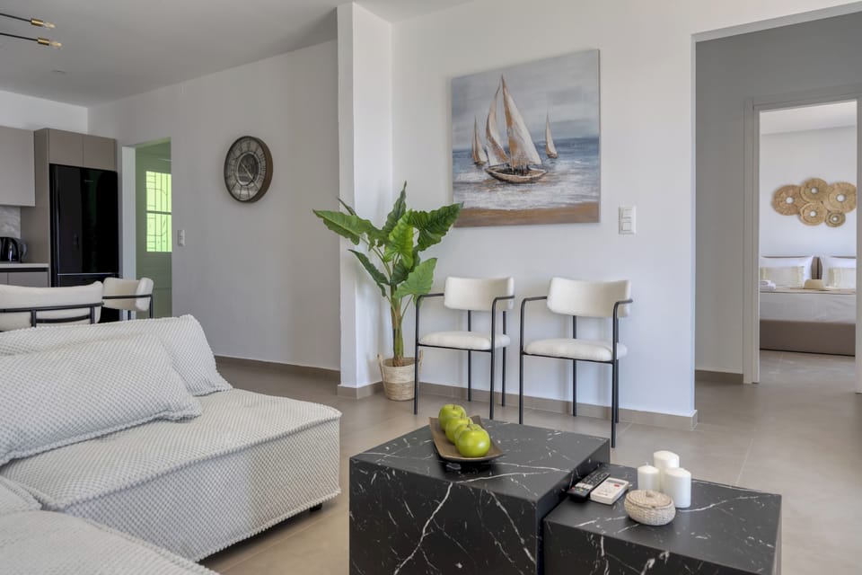 Spacious living area flowing into kitchen and bedroom entrance

