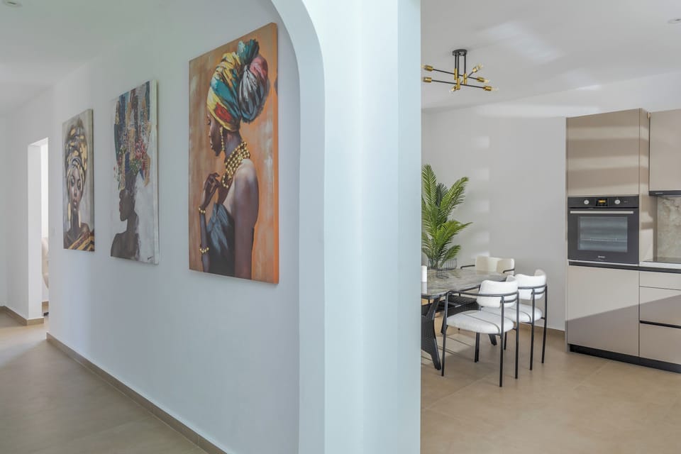 Hallway art and a glimpse into the kitchen and dining space

