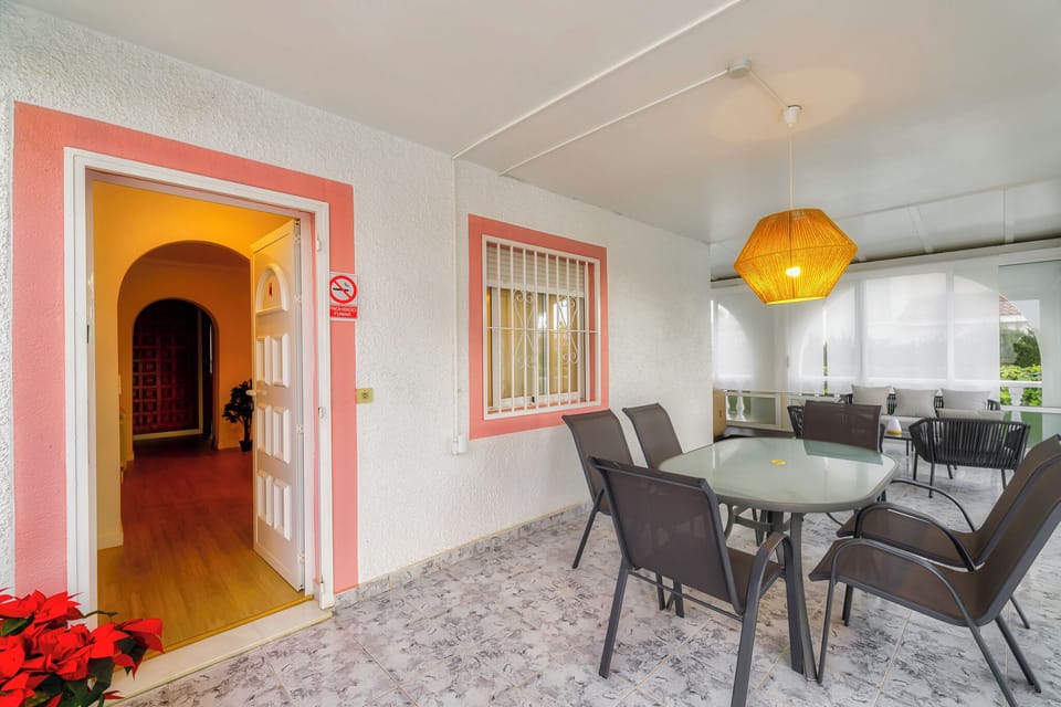 Sunny porch, ideal for relaxing and enjoying outdoor meals in a pleasant environment.