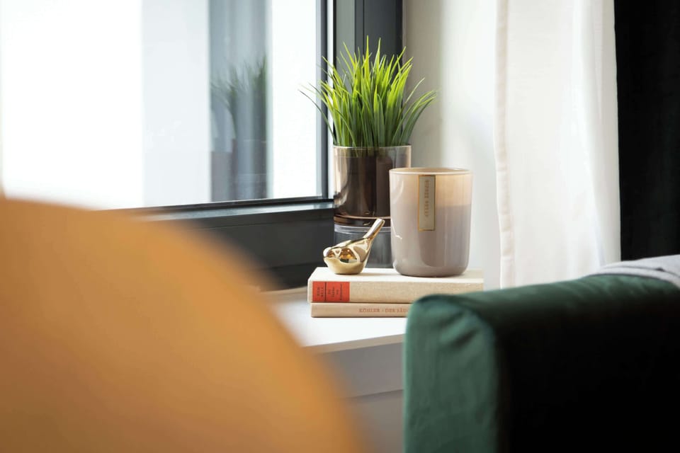 Candles, books, and greenery — thoughtful details that make the space feel alive and personal.