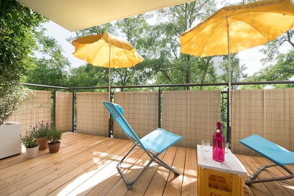 Big balcony with a new wooden floor and view to the river Spree. 