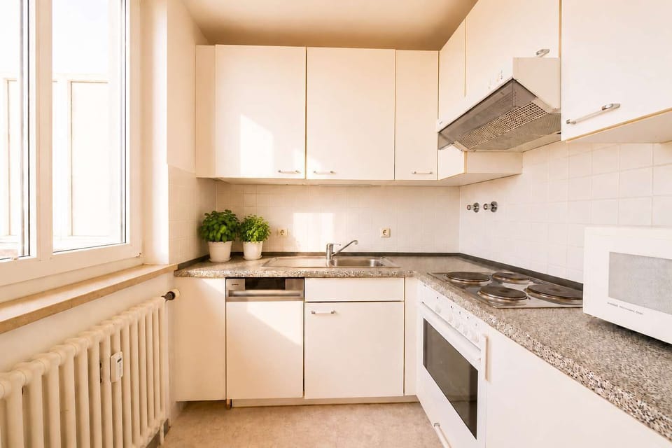 Compact kitchen with stove, oven, and essential appliances.