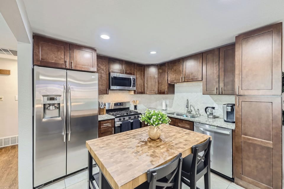 Kitchen with ample cupboards and kitchen island with bar seating for 2