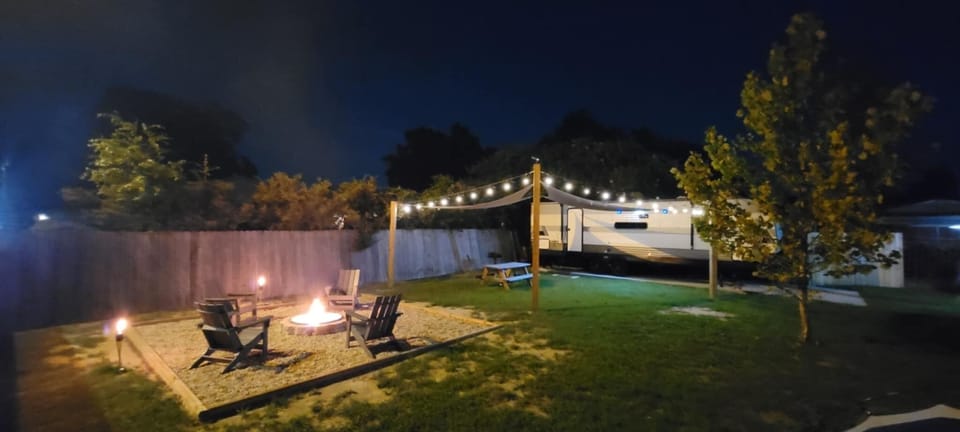 Grill dinner for outdoor dining under bistro lighting.