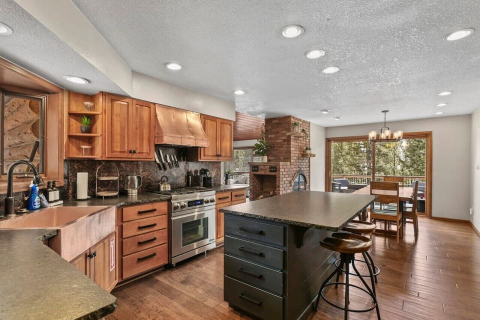 Kitchen with Copper sink and hood, island, gas stove and cooking essentials