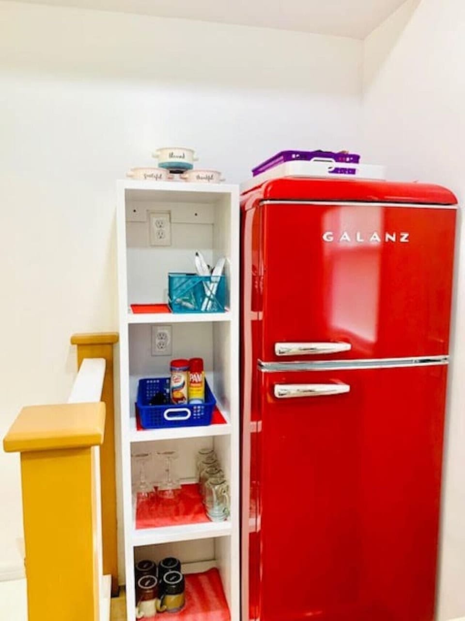Retro refrigerator and pantry shelving add charming vintage style and practical convenience to your mountain retreat.