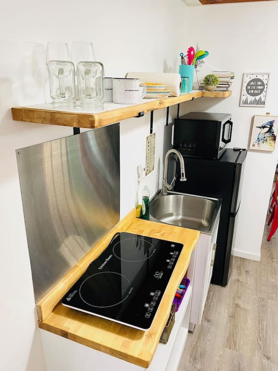 The suite has a kitchenette with a refrigerator/freezer combo, coffee brewer, tea pot, microwave, induction hot plate. Find plates, flatware and pots onsite.