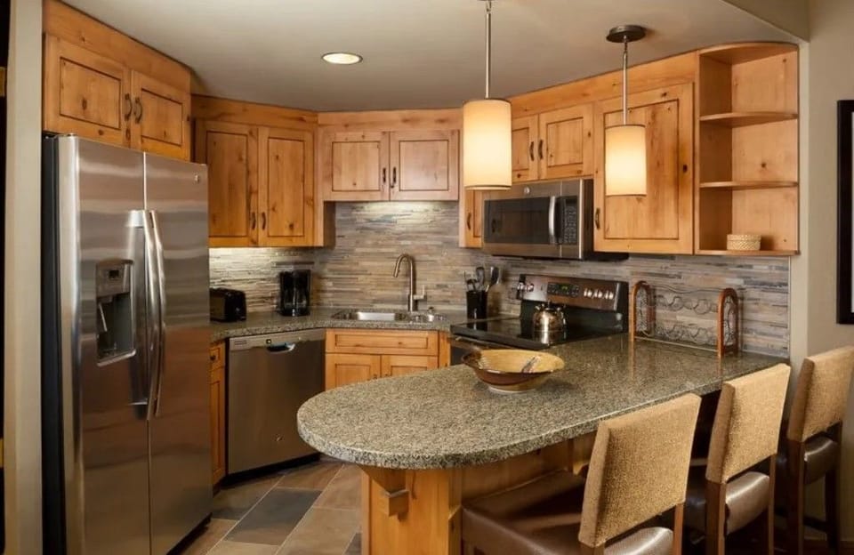 Fully equipped kitchen with modern appliances and a breakfast table.